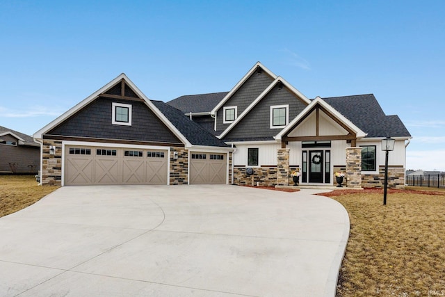 craftsman house with a garage and a front lawn