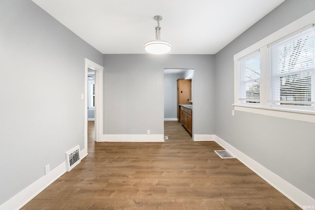 unfurnished dining area with wood-type flooring