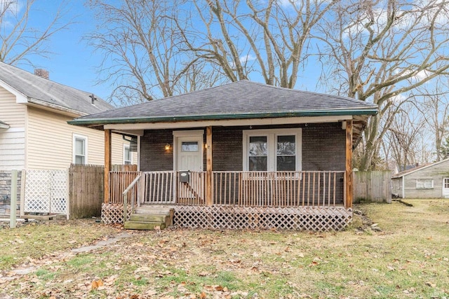 view of front of home with a front yard and covered porch