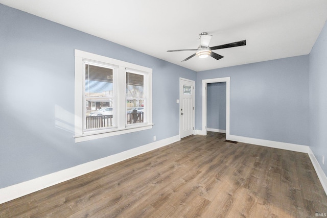 empty room with hardwood / wood-style flooring and ceiling fan