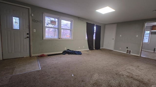 foyer entrance with carpet flooring