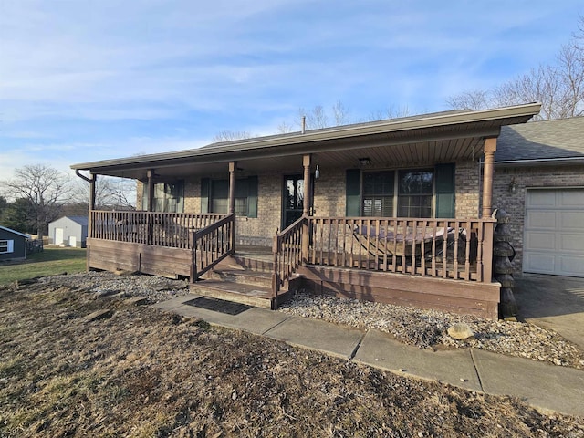 ranch-style house with a garage and a porch