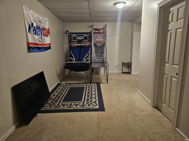 interior space with carpet floors and a paneled ceiling