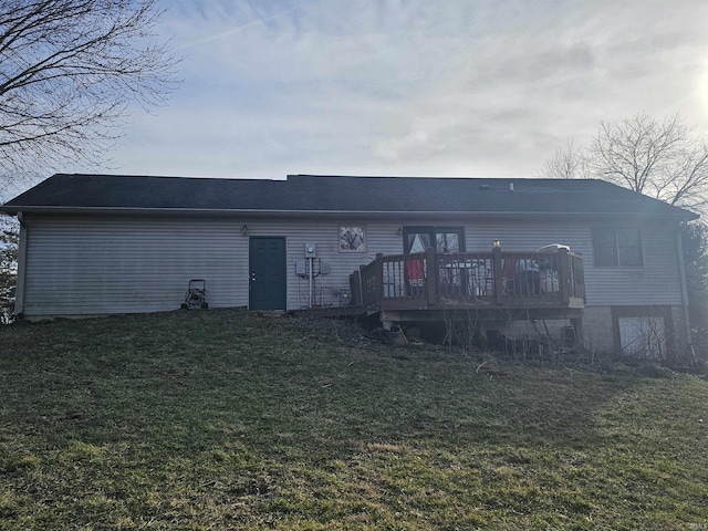 back of house featuring a wooden deck and a yard