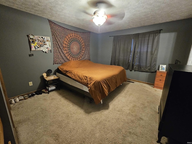 carpeted bedroom featuring ceiling fan and a textured ceiling