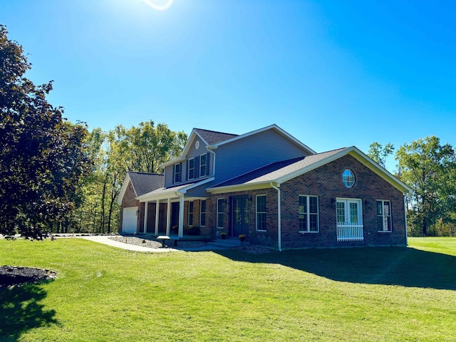 exterior space with a garage, covered porch, and a front lawn