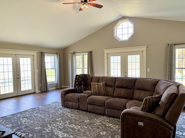 living room with lofted ceiling, dark hardwood / wood-style floors, a wealth of natural light, and french doors