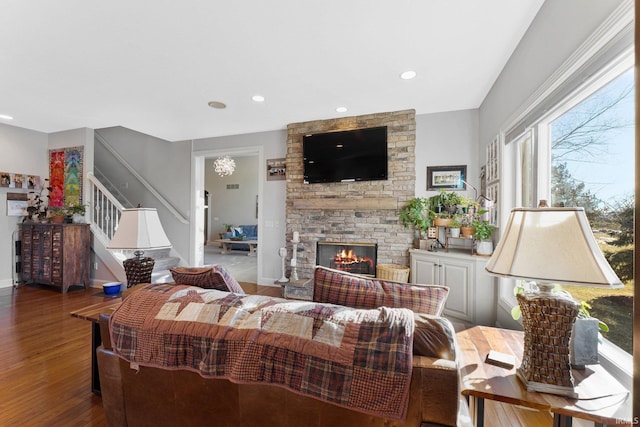 living room featuring wood-type flooring and a fireplace