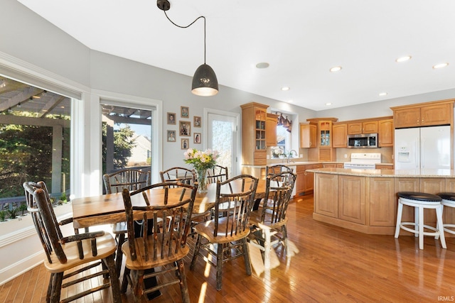 dining area featuring sink and light hardwood / wood-style flooring