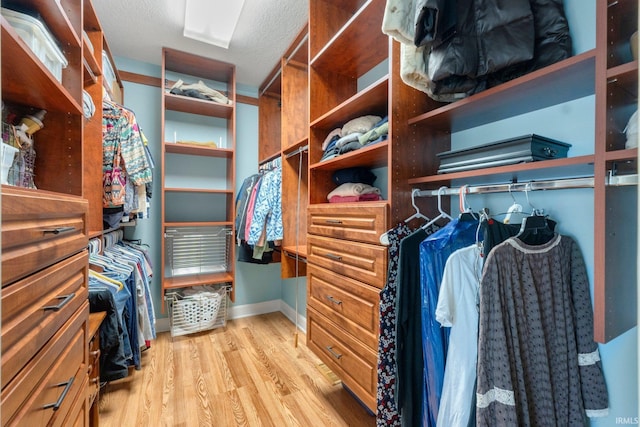 spacious closet with light hardwood / wood-style floors