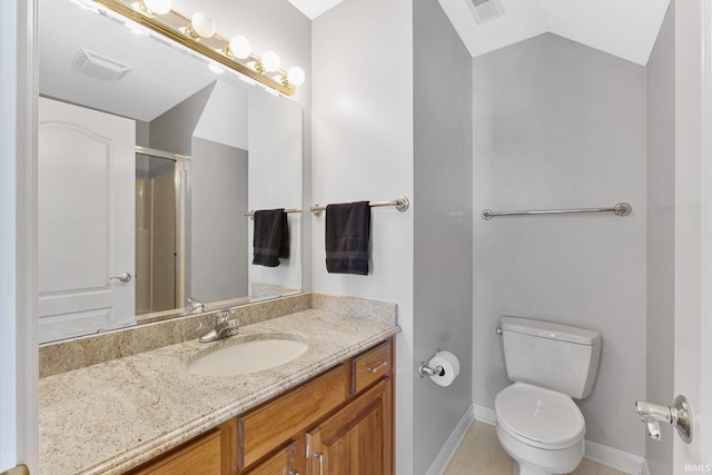 bathroom with vanity, vaulted ceiling, toilet, and walk in shower