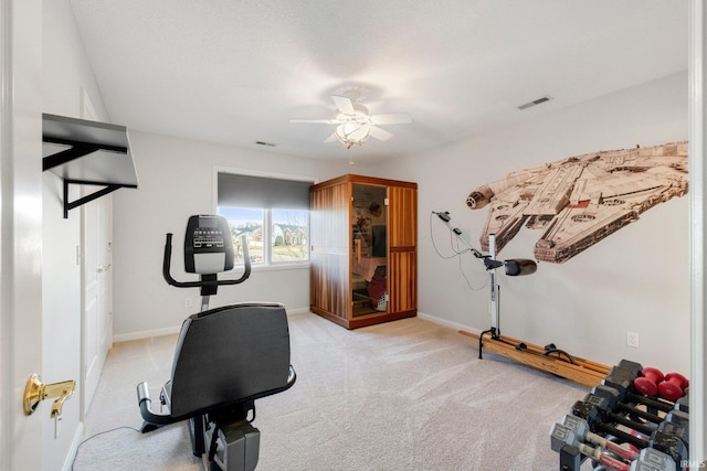 workout area with light colored carpet and ceiling fan