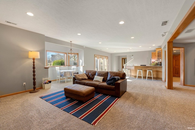 carpeted living room featuring a textured ceiling