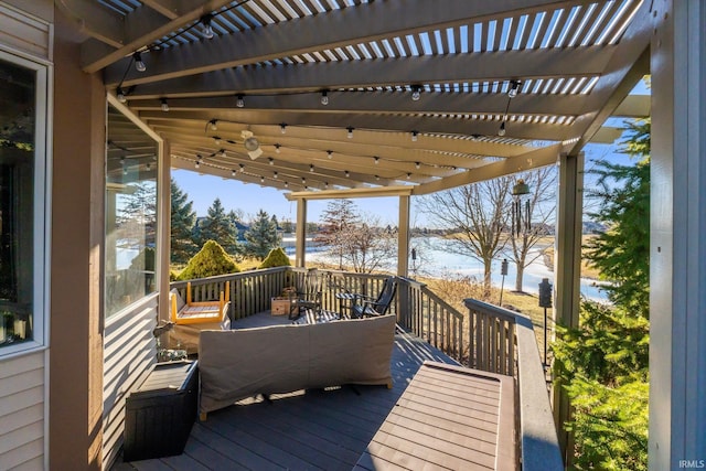 wooden deck featuring ceiling fan and a pergola