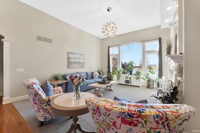 living room with a notable chandelier and hardwood / wood-style flooring