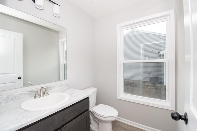 bathroom featuring vanity, hardwood / wood-style flooring, and toilet