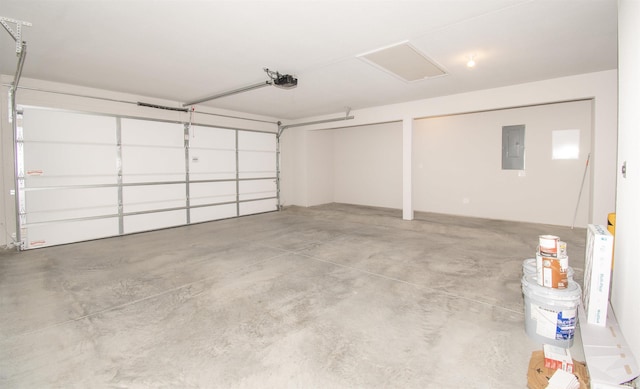 garage with a garage door opener and electric panel