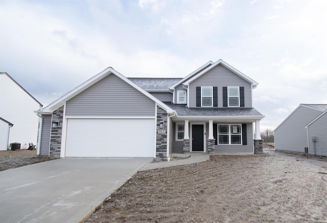 view of front of home featuring a garage, central AC, and covered porch