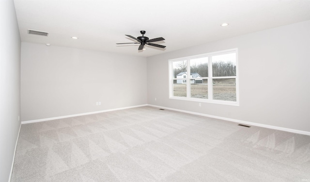 carpeted empty room featuring ceiling fan