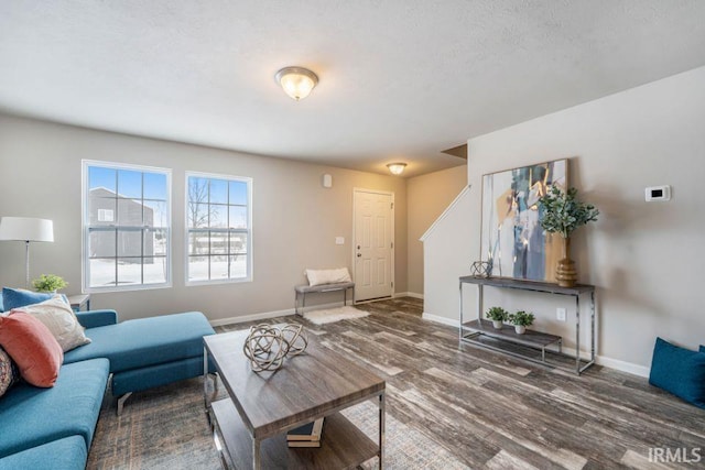 living room featuring dark hardwood / wood-style floors and a textured ceiling