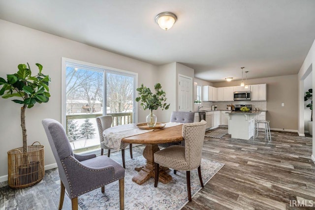 dining space with dark hardwood / wood-style flooring