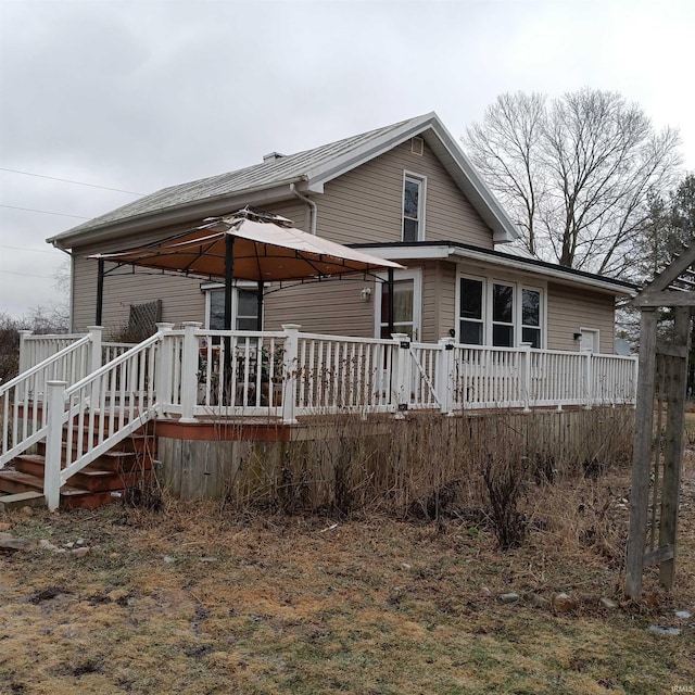 back of house with a gazebo and a deck