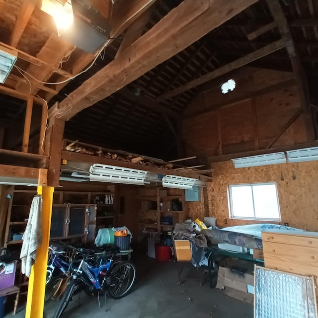 interior space with high vaulted ceiling and concrete floors