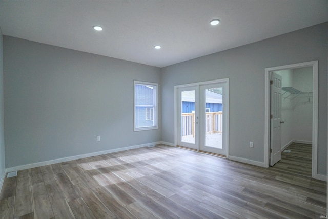 empty room featuring french doors and hardwood / wood-style floors