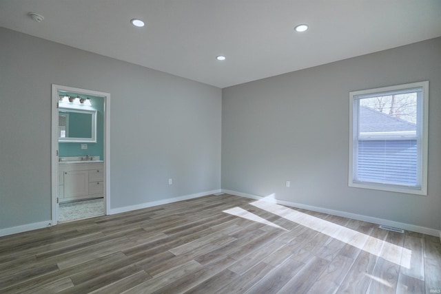 empty room with sink and light hardwood / wood-style flooring