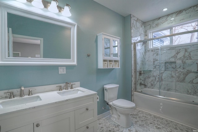 full bathroom featuring enclosed tub / shower combo, vanity, and toilet