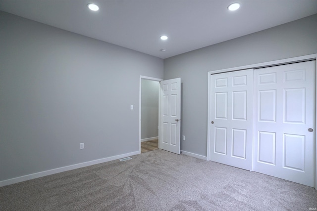 unfurnished bedroom featuring carpet floors and a closet