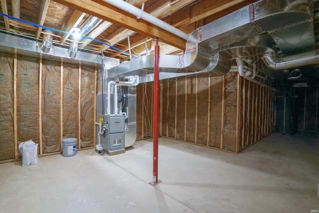 basement featuring heating unit and water heater