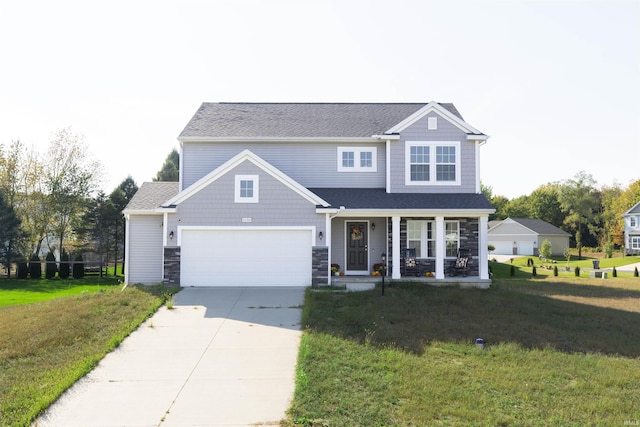 traditional-style house with driveway, covered porch, stone siding, and a front yard