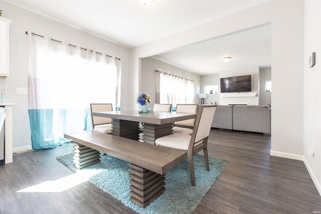 dining area with dark hardwood / wood-style flooring