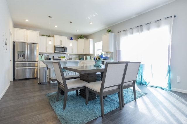 dining area featuring baseboards, dark wood-type flooring, and recessed lighting