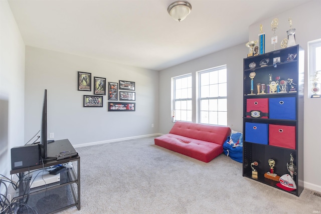 living area with carpet flooring and baseboards