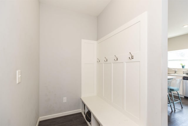 mudroom featuring dark wood-style flooring and baseboards