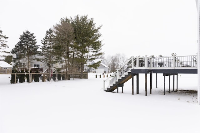 snowy yard featuring stairs