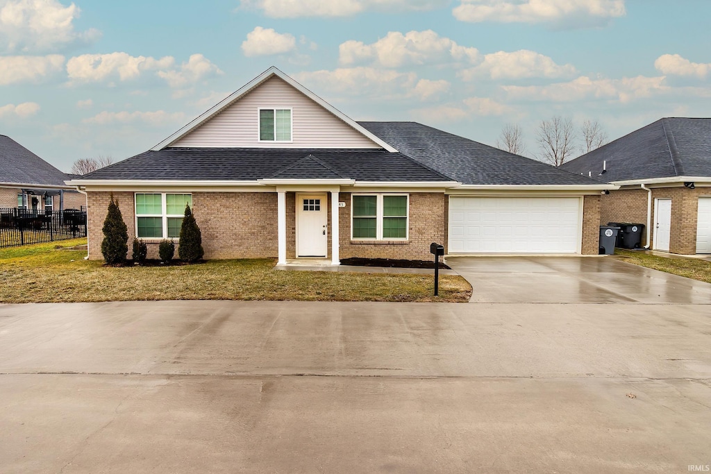 view of front of house featuring a garage and a front lawn