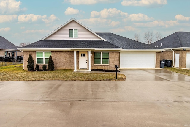 view of front of house featuring a garage and a front lawn