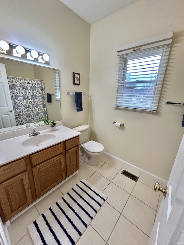 bathroom featuring tile patterned flooring, vanity, and toilet