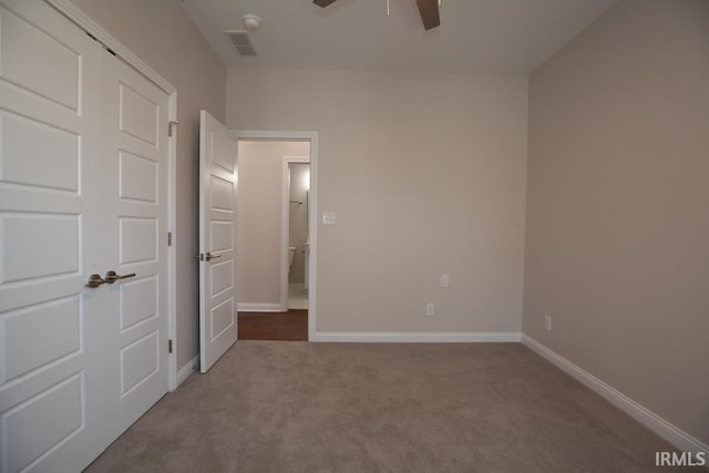 unfurnished bedroom with ceiling fan, carpet flooring, and a closet