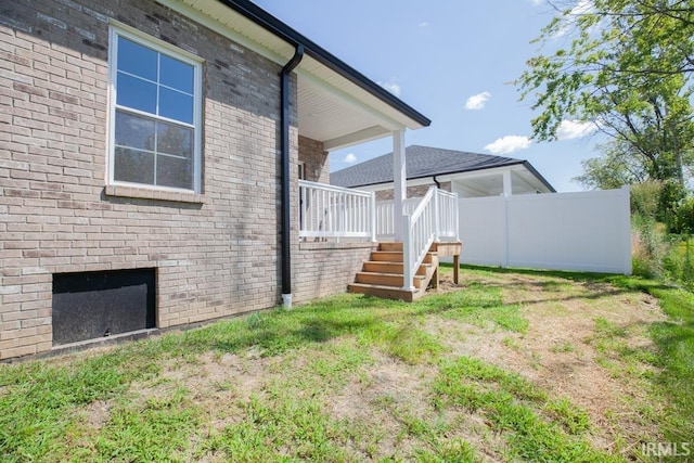 rear view of house with a yard