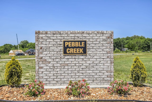 community / neighborhood sign with a lawn