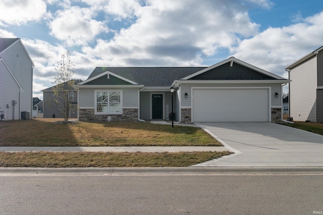 view of front facade with cooling unit, a garage, and a front lawn