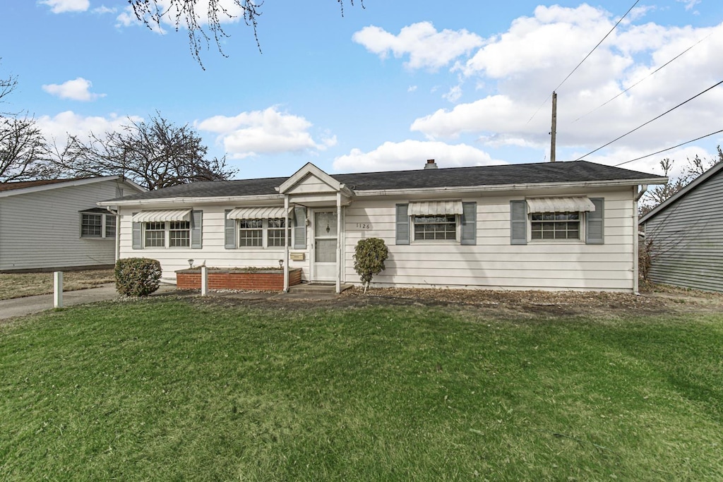 ranch-style home with a front lawn