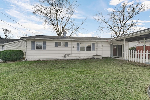 rear view of property featuring a yard