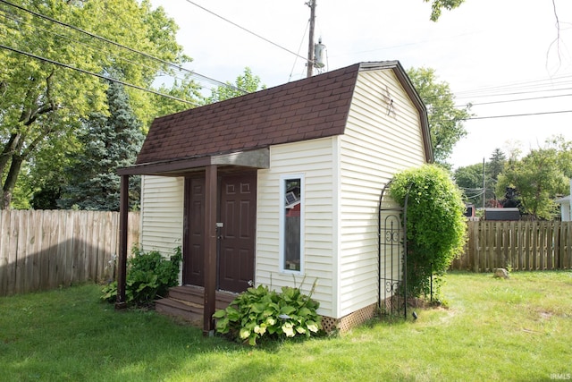 view of outbuilding featuring a lawn