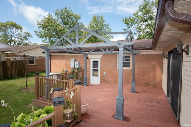 wooden deck with a lawn and a pergola