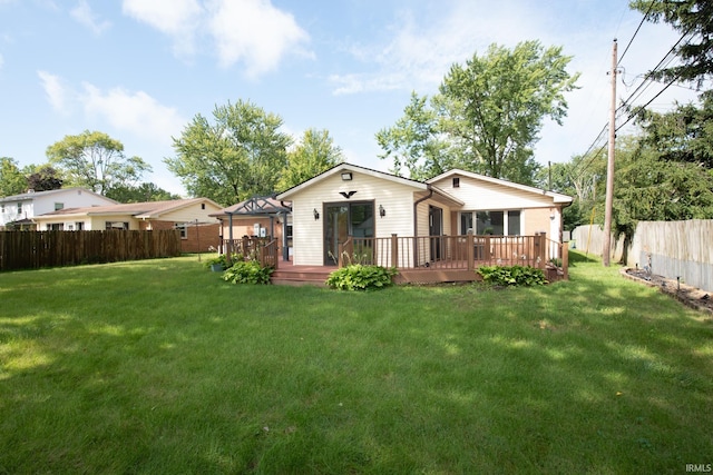 back of house featuring a gazebo, a deck, and a lawn